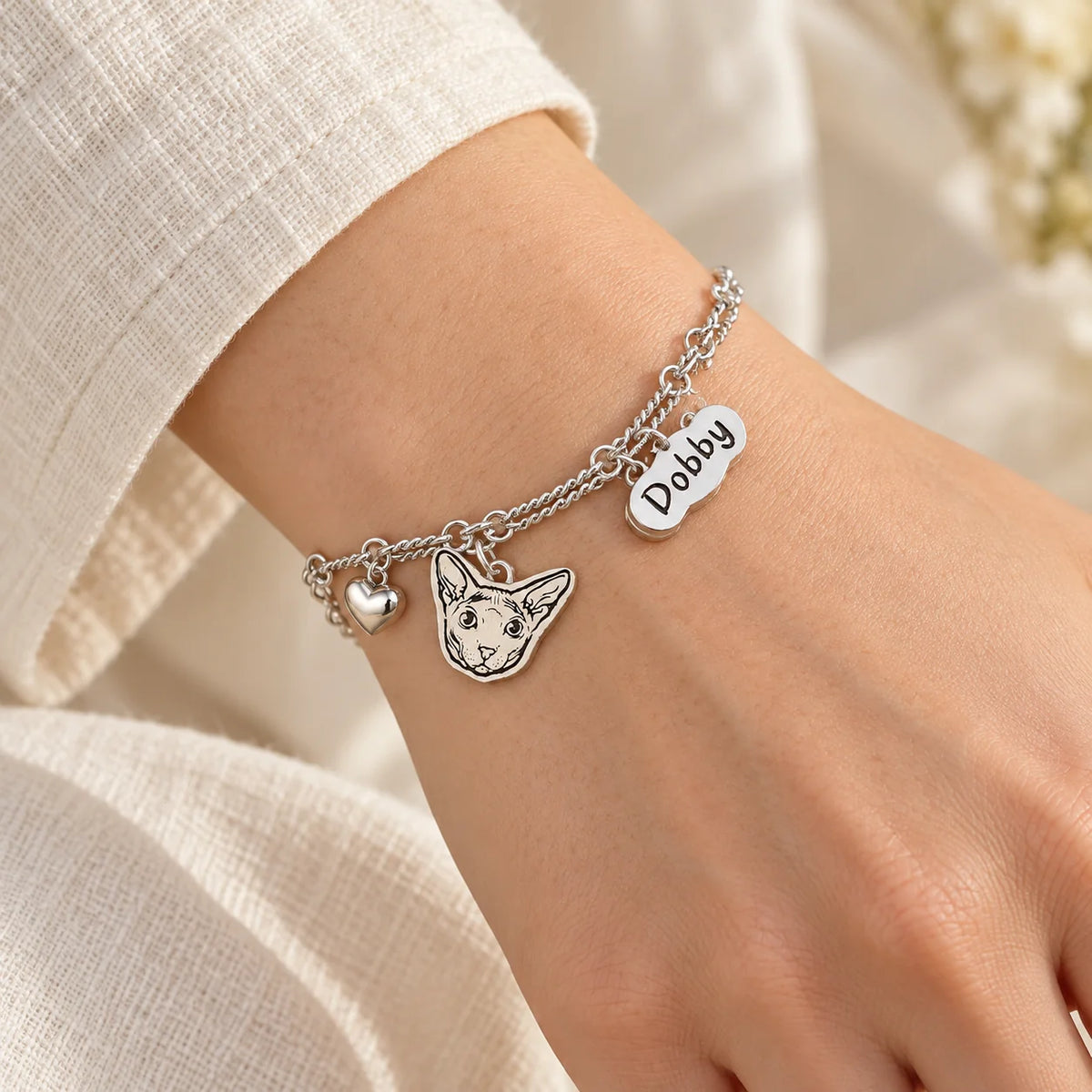Personalized silver pet portrait name bracelet worn in natural light