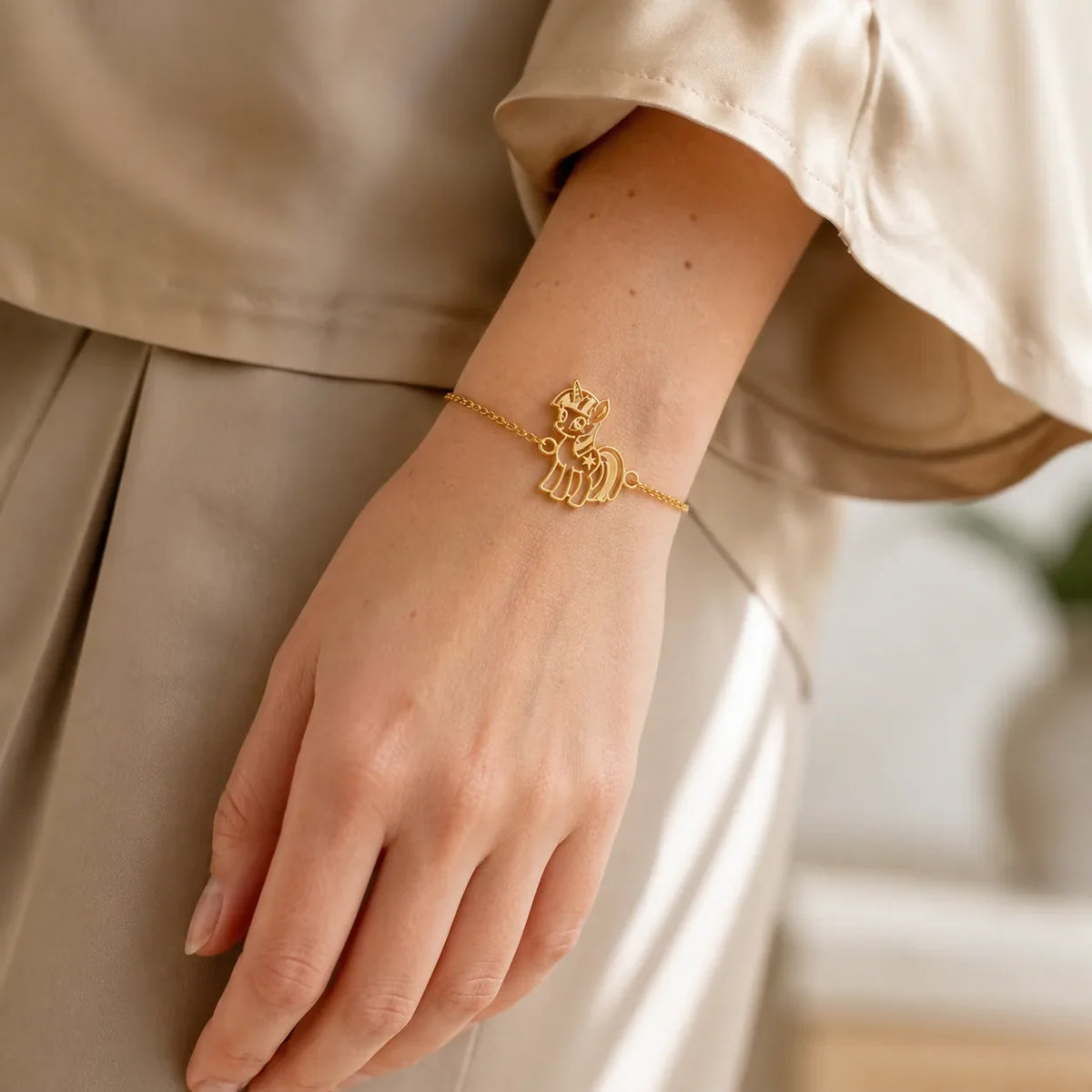 DRAWELL gold tone custom drawing chain bracelet worn on wrist