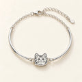 Silver half-bangle bracelet with cat portrait connecting its curved arms