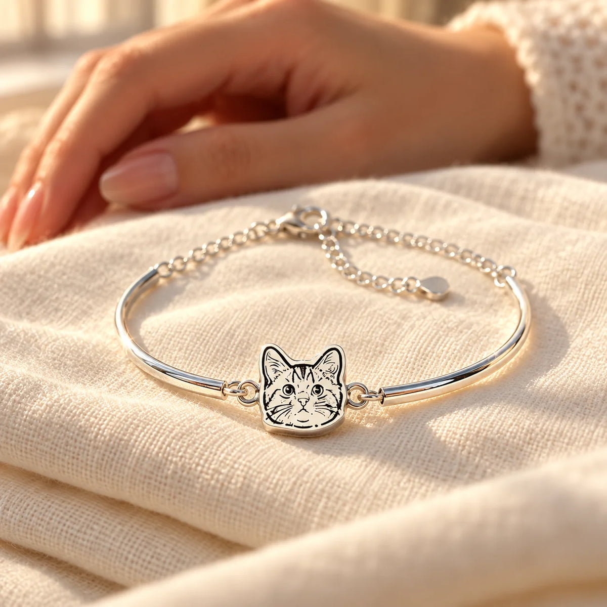 Personalized silver pet portrait bangle keepsake on ivory linen