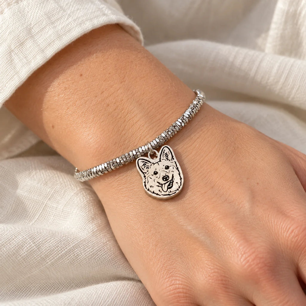 Personalized silver pet portrait bracelet worn in natural light