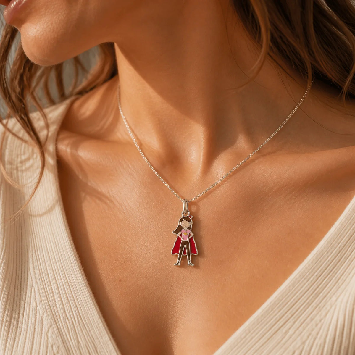 Woman wearing a custom enamel DRAWELL necklace in silver finish